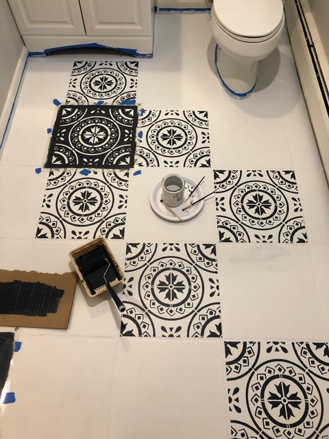 many floor stencils removed from tile and painted in black