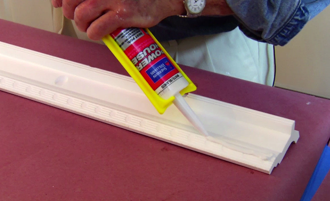 Applying caulk to crown molding