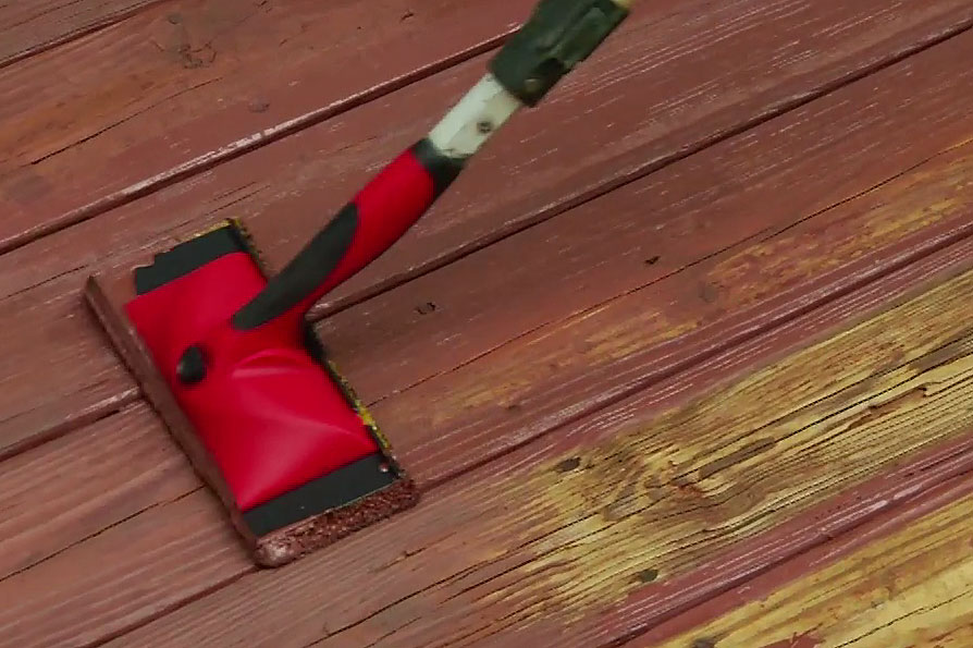 Applying stain to deck 