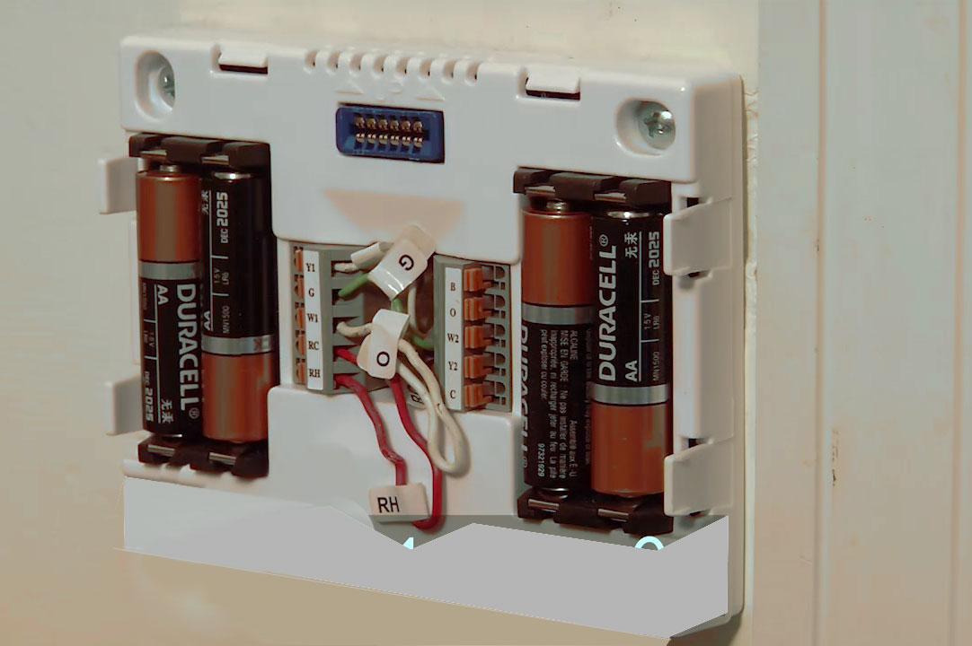 Four Duracell batteries in back of thermostat