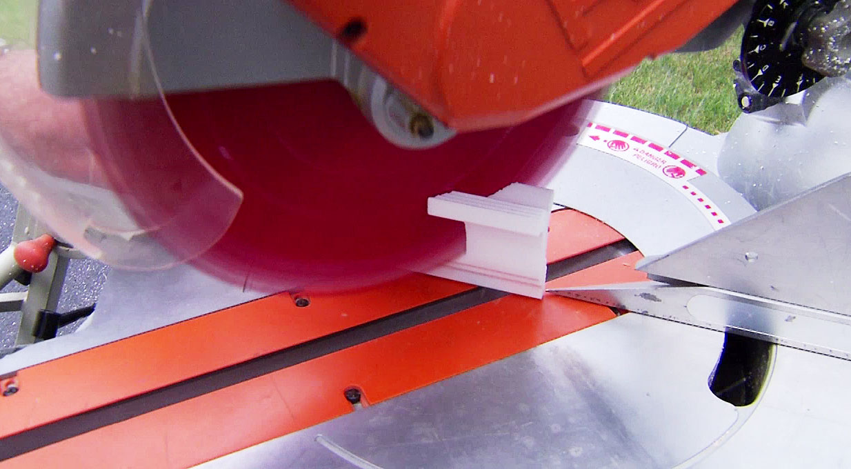 Man cutting crown molding with miter saw