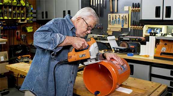 Man cutting bucket