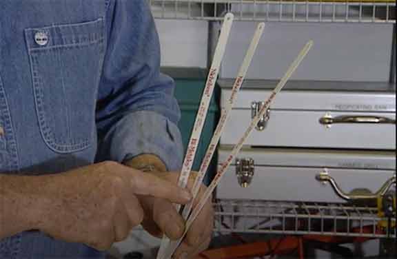 Man demonstrates three hacksaw blades