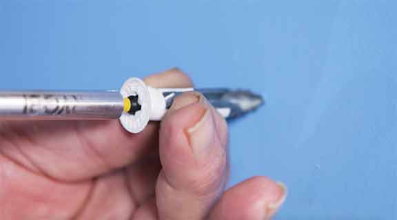 Man drills wall anchor into drywall