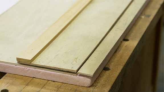 Man makes saw guide out of wood