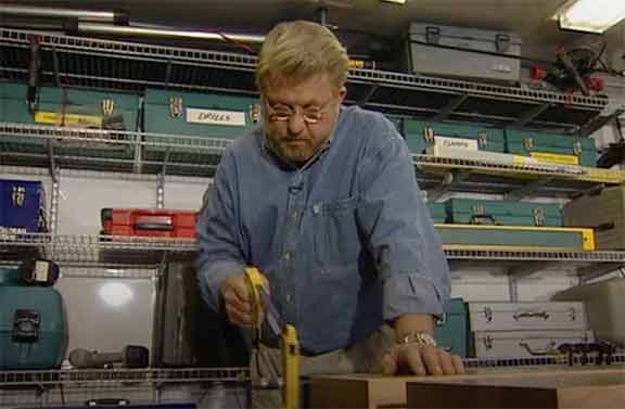 Man uses a hacksaw blade to cut metal rod