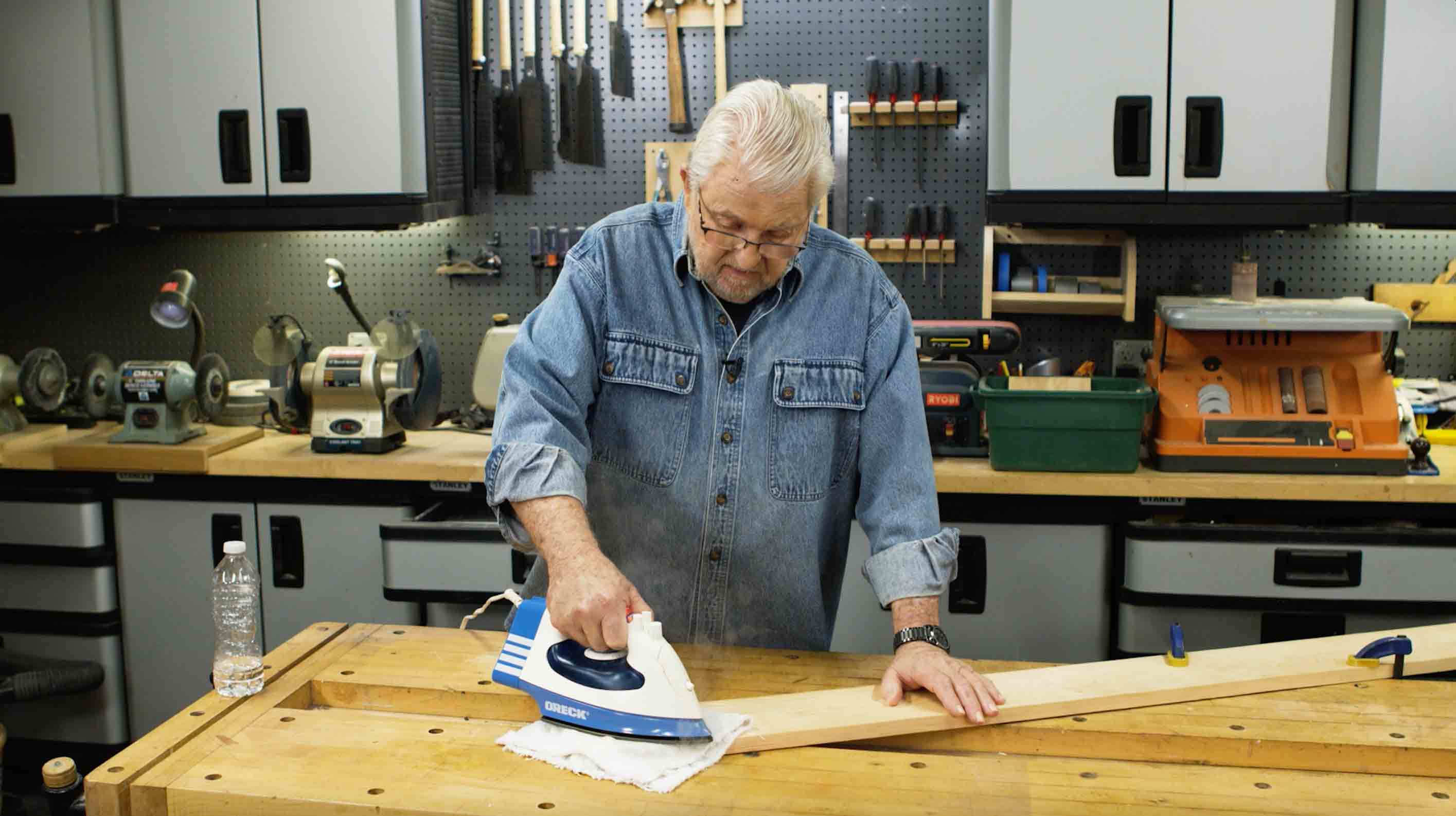 using steam from an iron to remove dent in wood