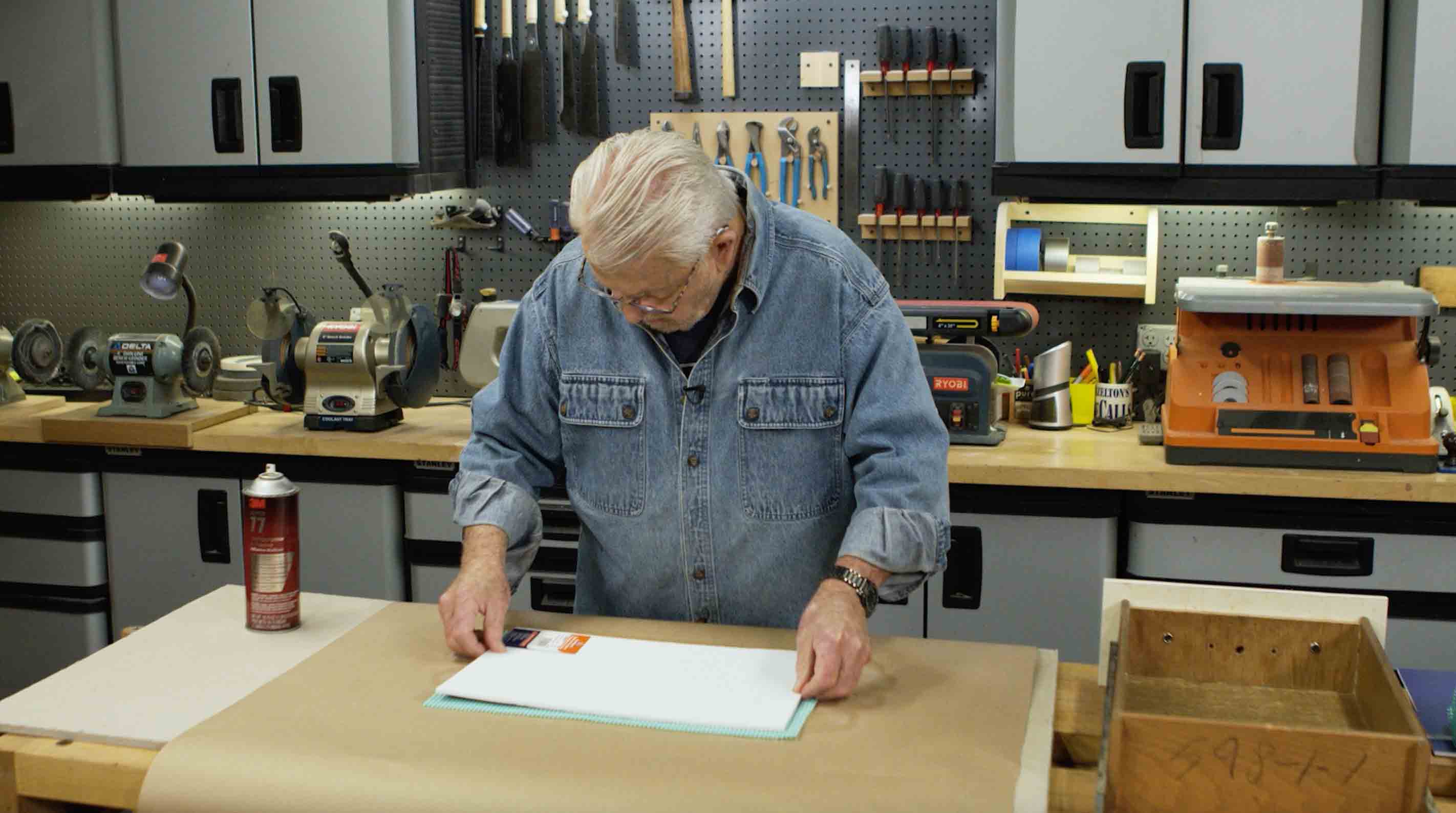 Man glueing foam core onto drawer liner