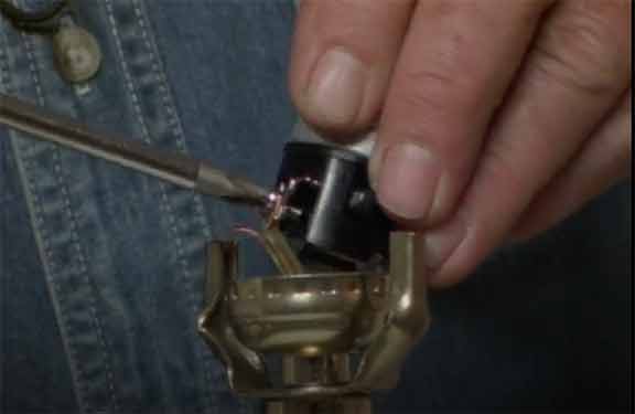 Man uses screwdriver on lamp socket