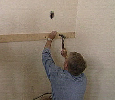 Man nailing a ledger strip 
