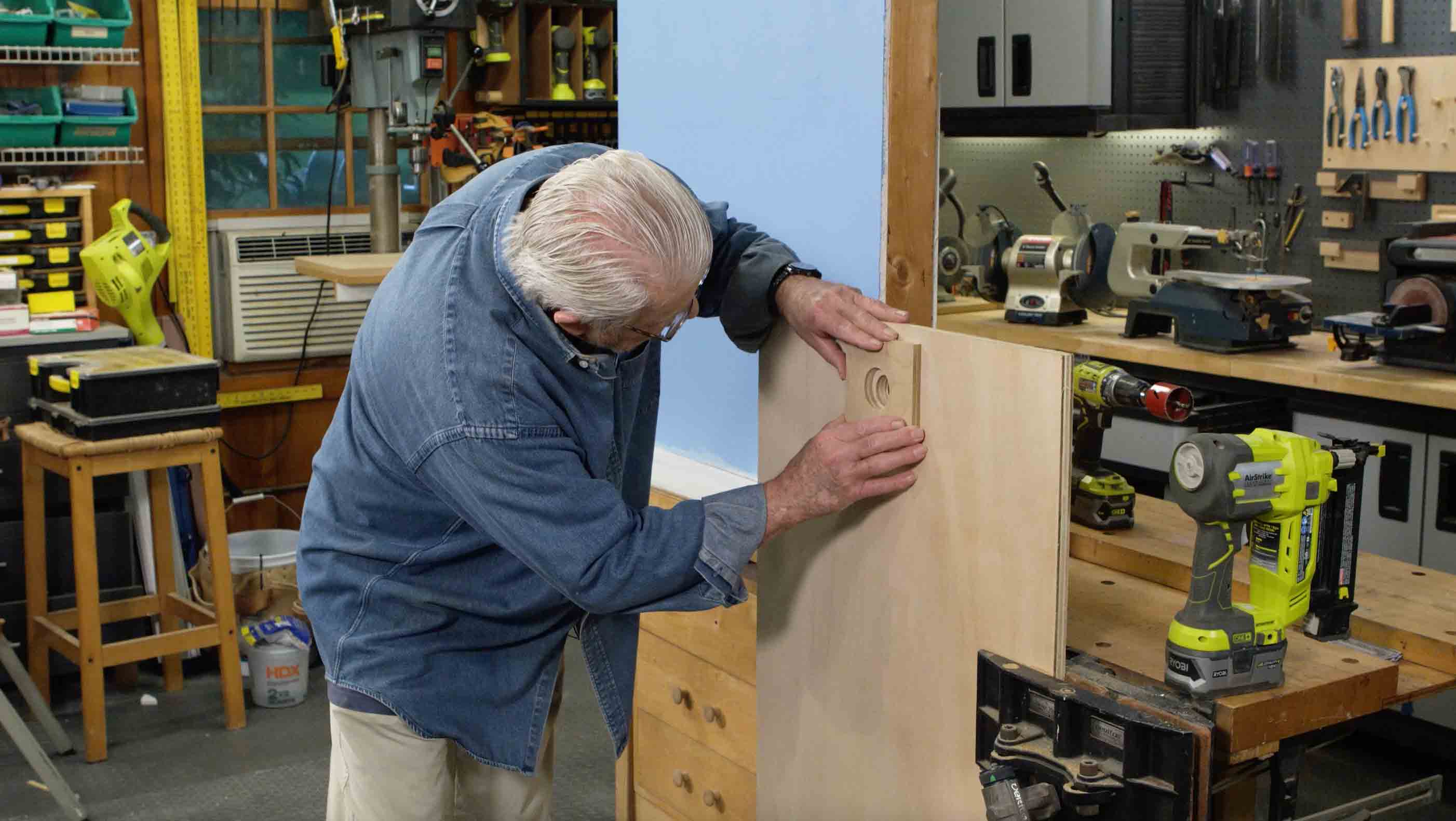 Man positions wooden template before drilling 