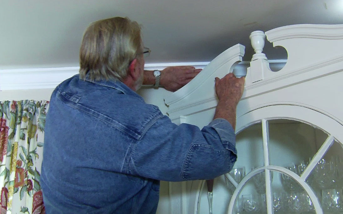 Man pressing crown molding in place 