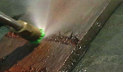 A power washer being held too close to the wood actually etches the wood