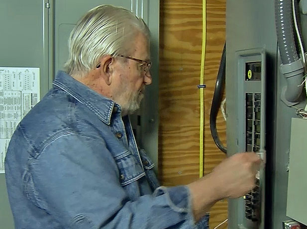 Ron standing near breaker panel 