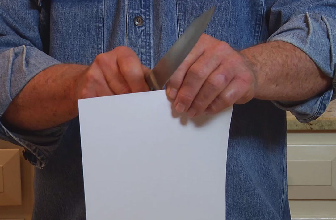 Images: Cutting a piece of paper to test a knife's sharpness